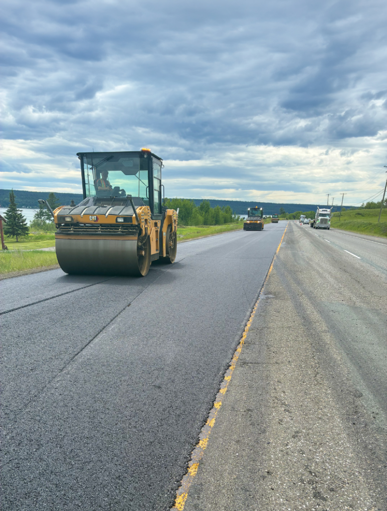 Dawson Construction asphalt roller compacting fresh pavement on Highway 97 near Lac La Hache, BC