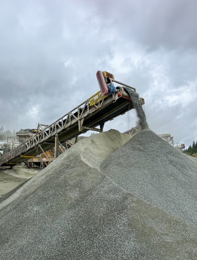 Crushed aggregate stockpile with conveyor at Highway 5 CN Junction to Rayleigh site near Kamloops